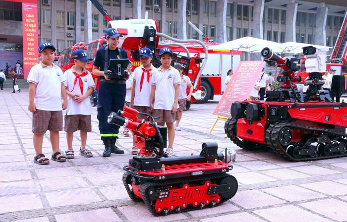 Cán bộ Phòng Cảnh sát PCCC và CNCH Công an TP Hà Nội hướng dẫn các em học sinh tìm hiểu về các thiết bị, phương tiện chữa cháy hiện đại.