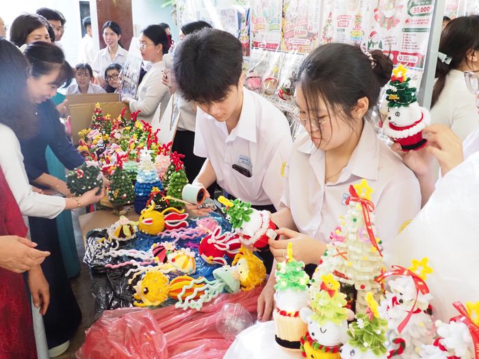  Học sinh giới thiệu và mời khách tham dự mua các sản phẩm từ vật liệu tái chế 