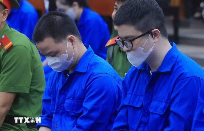 Bị cáo Lê Khắc Ngọ (tức Mr Hunter, bên trái) và bị cáo Phó Đức Nam (tức Mr Pips) tại phiên xét xử sáng 27/10. (Ảnh: Phạm Kiên/TTXVN)