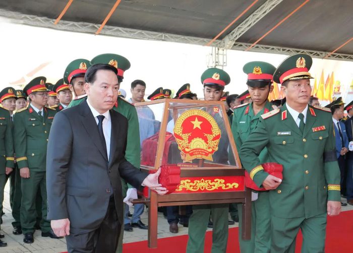 Đồng chí Hồ Xuân Trường cùng các đại biểu và lực lượng tiêu binh di chuyển các hài cốt liệt sĩ đến ô mộ để an táng.