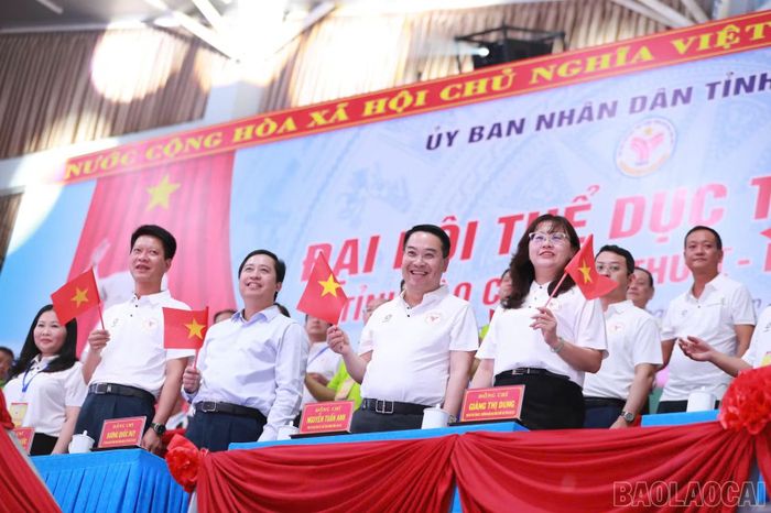 Các đại biểu cổ vũ, chào mừng các đoàn vận động viên diễu hành qua lễ đài.