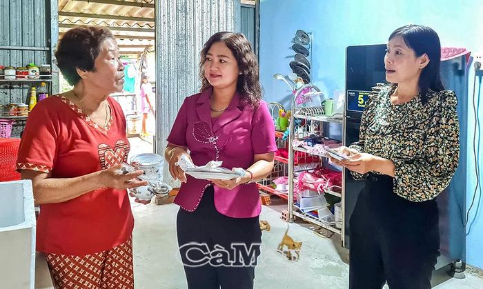 Vợ ông Huỳnh Minh Hoàng (bìa trái) chia sẻ niềm vui với bà Trần Mộng Nghi, Chủ tịch Uỷ ban MTTQ Việt Nam xã Vĩnh Mỹ (đứng giữa), khi được hỗ trợ xây dựng nhà Ðại đoàn kết và trao tặng nhiều vật dụng sinh hoạt thiết yếu.