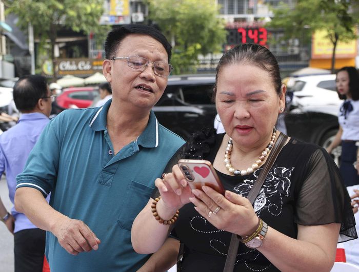 Người dân trải nghiệm Wi-Fi miễn phí tại tuyến phố Minh Khai, phường Vĩnh Tuy. Ảnh: PV