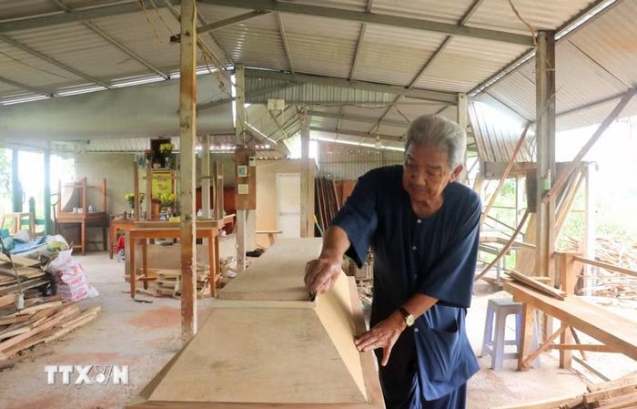 Hằng ngày, ông Lê Quang Trưởng vẫn tất bật tất bật xẻ gỗ, chuẩn bị vật liệu làm nhà tình thương và đóng quan tài miễn phí cho người nghèo. (Ảnh: Công Mạo/TTXVN)