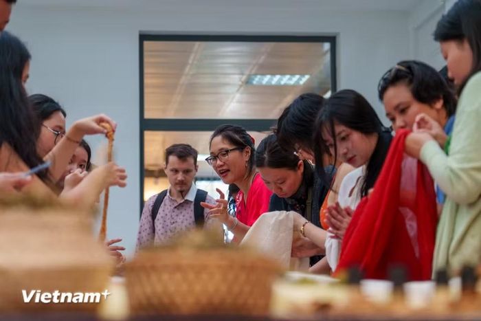 Không gian workshop “Hương lụa Đồng Dương” thu hút đông đảo du khách trong nước và quốc tế cùng tìm hiểu về kỹ nghệ ươm tơ, dệt lụa và thảo mộc tự nhiên. (Ảnh: Thanh Phong/Vietnam+)