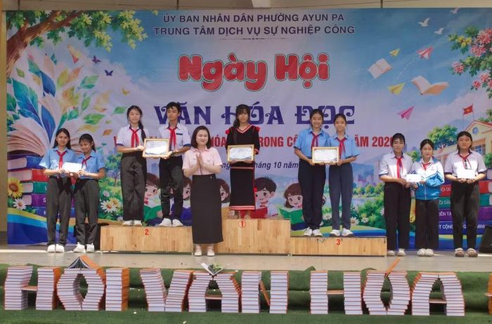  Ban tổ chức trao giải cho các đội thi xuất sắc nhất phần thi giới thiệu sách bậc THCS. Ảnh: Vũ Chi 