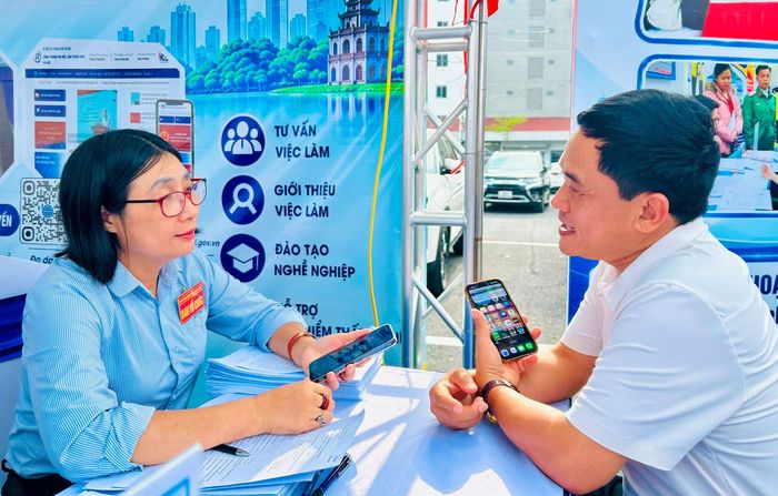 Nhân viên Trung tâm Dịch vụ việc làm Hà Nội tư vấn việc làm cho người lao động. Ảnh: Trần Oanh.